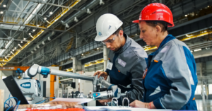 Operators working with a punch press control system featuring programmable limit switches (PLS), ensuring precise operations and enhanced safety.