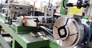 Close-up of a malfunctioning press machine with warning lights indicating safety issues.