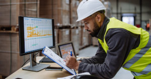 Concerned employee reviewing operational data on a control panel, indicating potential safety concerns.