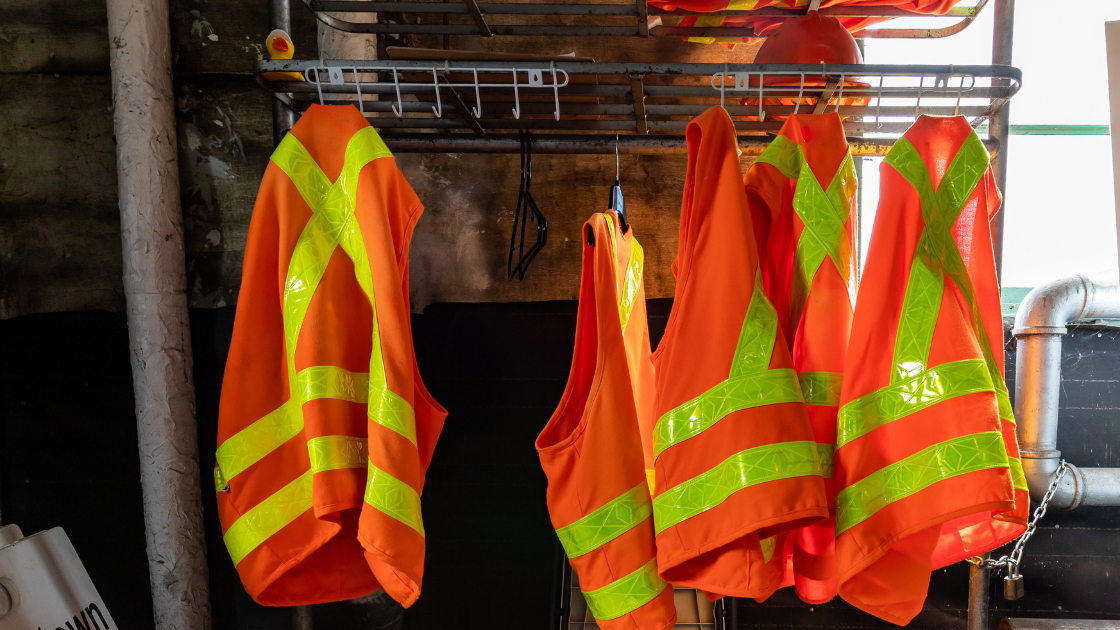 Various safety equipment and protocols in a workplace, emphasizing machine guarding, employee communication, and compliance with safety standards.