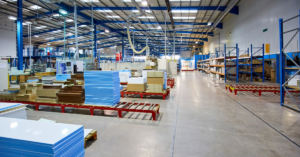 Wide view of a press floor with industrial machinery and workstations, highlighting an active manufacturing environment.