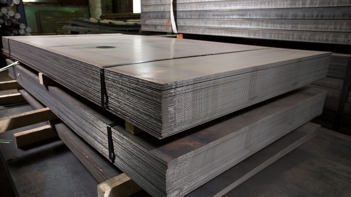 Sheets of metal in a stamping press, highlighting the importance of tonnage monitoring for precision, press safety, and efficient metal stamping.