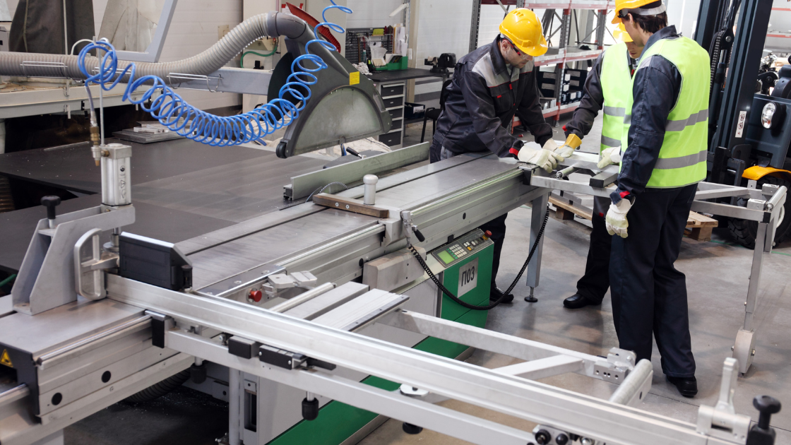 Plant floor with a few employees in safety gear demonstrating the use of time-based brake monitoring on a pressroom floor.