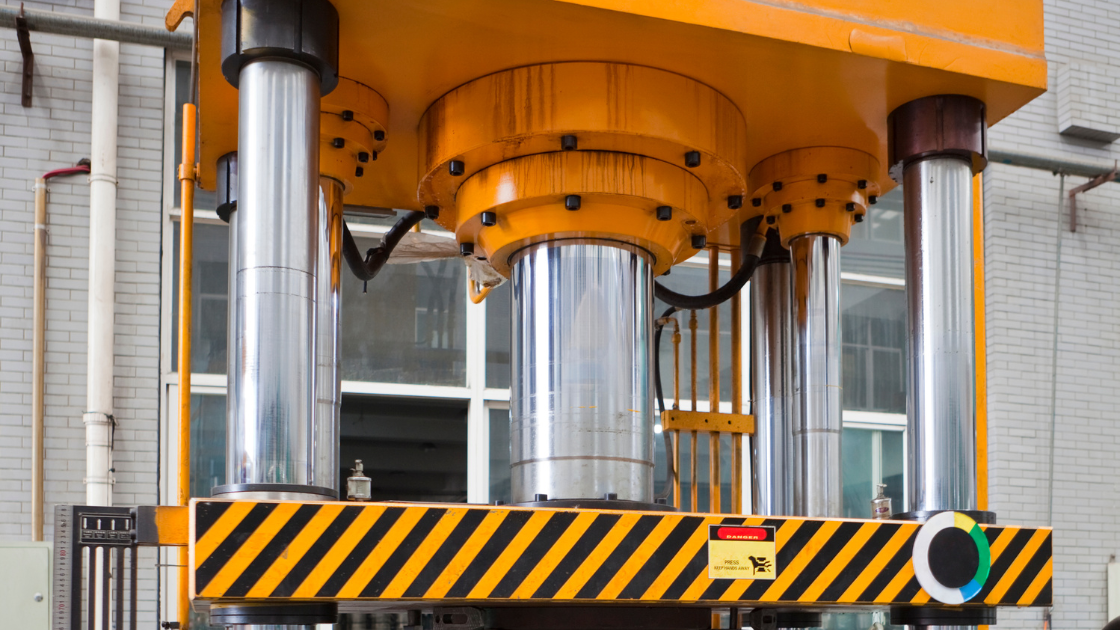 Industrial press machine in a pressroom, equipped with press safety controls and automation systems for metal stamping operations.