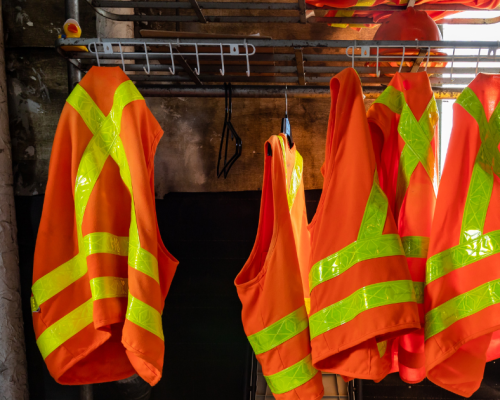 Various safety equipment and protocols in a workplace, emphasizing machine guarding, employee communication, and compliance with safety standards.