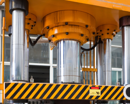 Industrial press machine in a pressroom, equipped with press safety controls and automation systems for metal stamping operations.